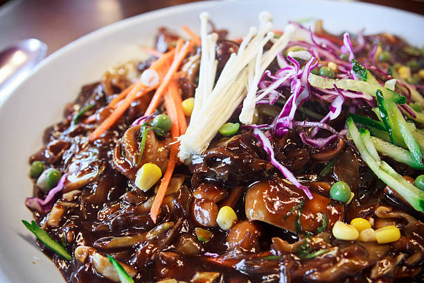 Jajangmyeon, noodle dish topped with a thick sauce Jajangmyeon, Korean noodle dish topped with a thick sauce banchan stock pictures, royalty-free photos & images