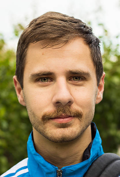 istock Young man with a mustache smiling at the camera 505551731