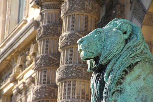 View on statue of lion near Louvre museum in Paris