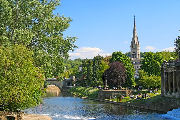 Pastoral scene in Bath, England on the River Avon Pastoral scene in Bath, England on the River Avon on a sunny day with blue sky bath england stock pictures, royalty-free photos & images