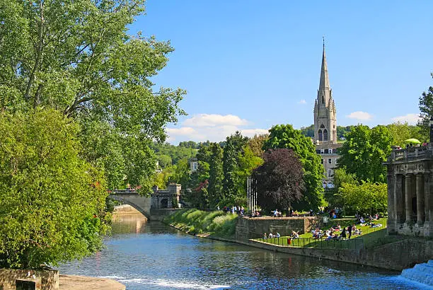 Pastoral scene in Bath, England on the River Avon on a sunny day with blue sky