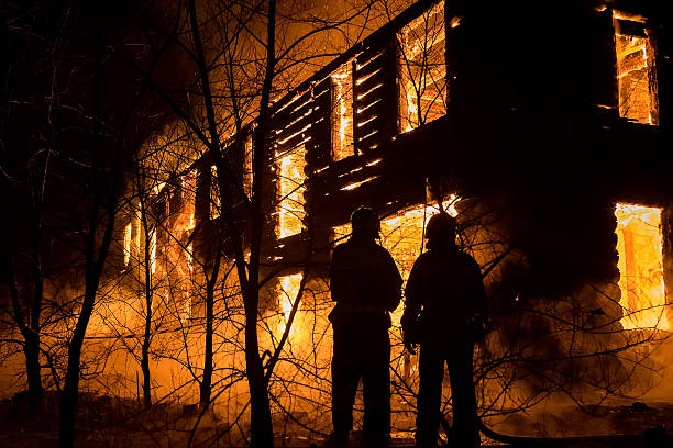 istock Firemans Trying to Safe House on Fire. Firefighter Emergency Ext 505568156