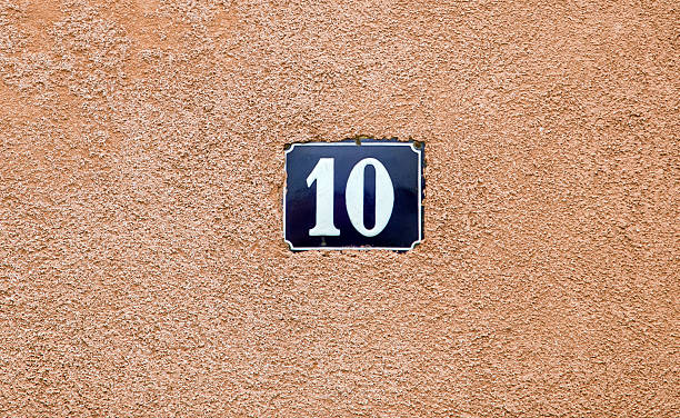 istock enameled house number ten. Blue lettering on wall background. 505569349