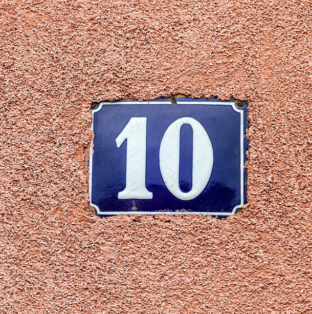istock enameled house number ten. Blue lettering on wall background. 505569351