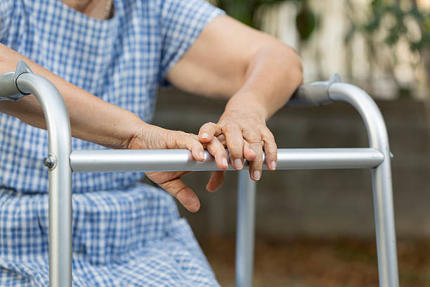 istock Elderly sitting in backyard with walker. 505571158