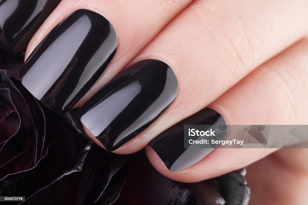 Very balack nails Very beautiful black nails closeup of a flower. Manicure Stock Photo