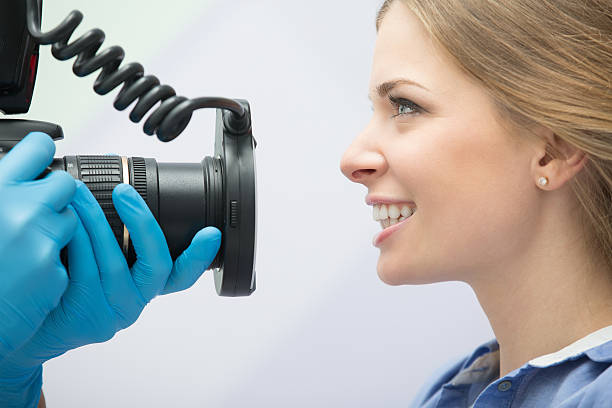 Dentist with camera and patient stock photo