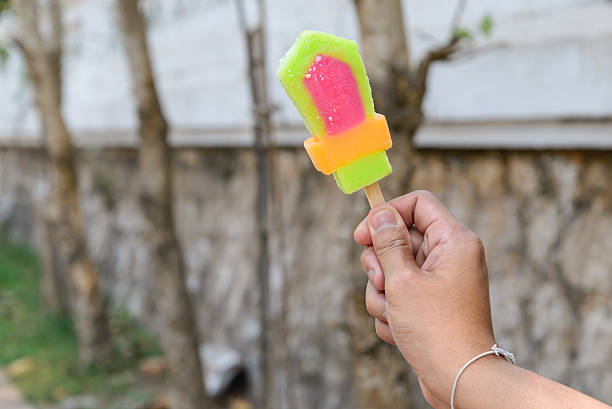 Colorful popsicle in hand.