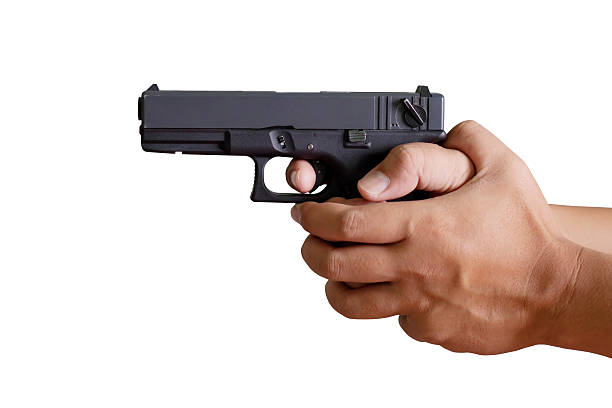 istock White hand holds gun isolated on white background. 505575796