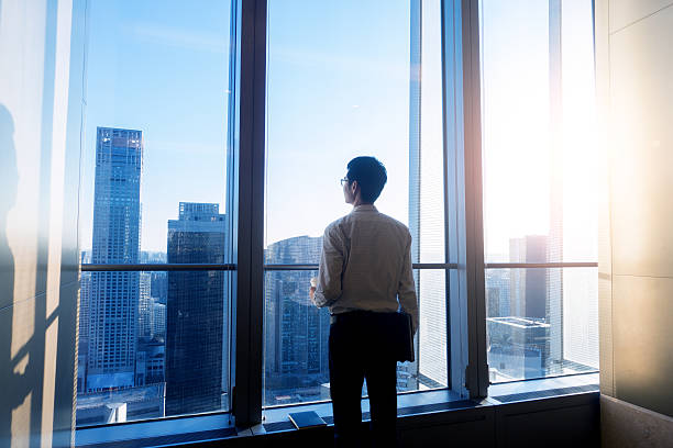 istock Businessman looking cityscape through the office window 505576794