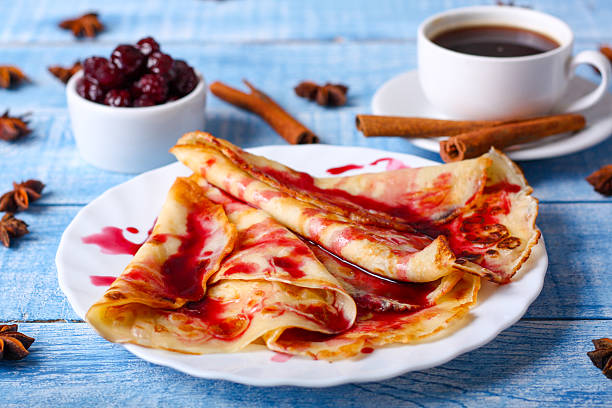 istock Breakfast pancakes with cherry jam on a blue background 505577472