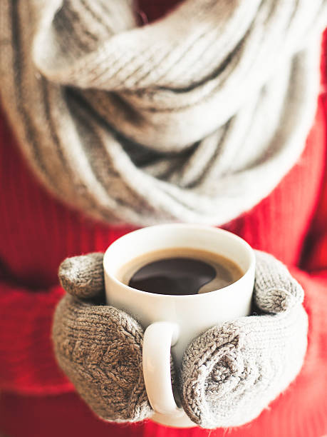 istock Woman hands in gloves holding a mug 505578016