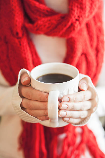 istock Woman hands in gloves holding a mug 505578212