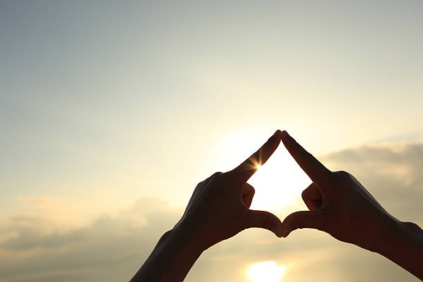 istock frame made by hands against sunrise on sea 505578504