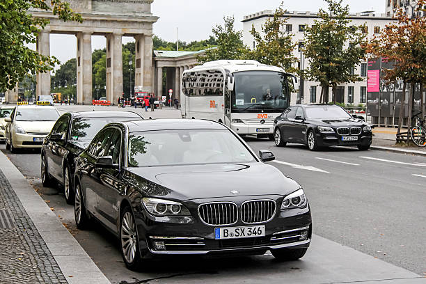 Berlin, Germany - September 10, 2013: Luxury motor cars BMW F02 7-series are parked in the city street near the hotel and Brandenburg Gate.