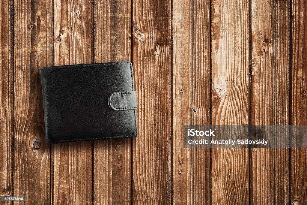 Black leather wallet on wooden table Black Color Stock Photo