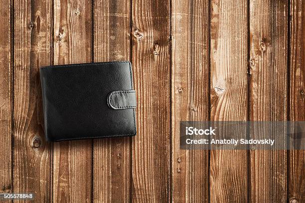 Black Leather Wallet On Wooden Table Stock Photo - Download Image Now - Black Color, Wallet, Change Purse