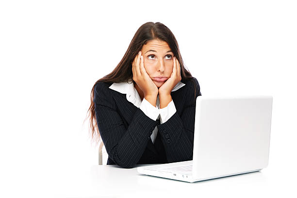 Bored laptop woman at work stock photo