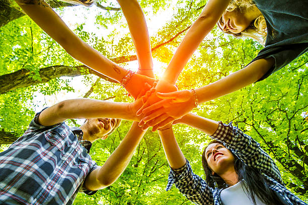 Group of friends with hands in hands - Teamwork