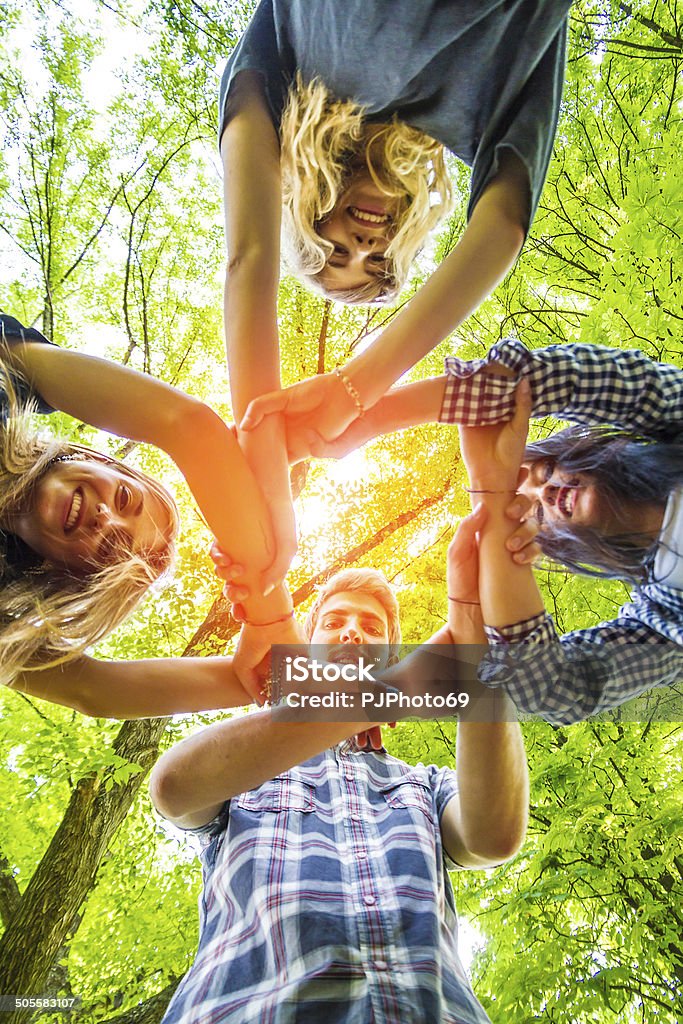 Group of friends with hands in hands - Teamwork Group of friends with hands in hands with sunlight - Teamwork Summer Camp Stock Photo