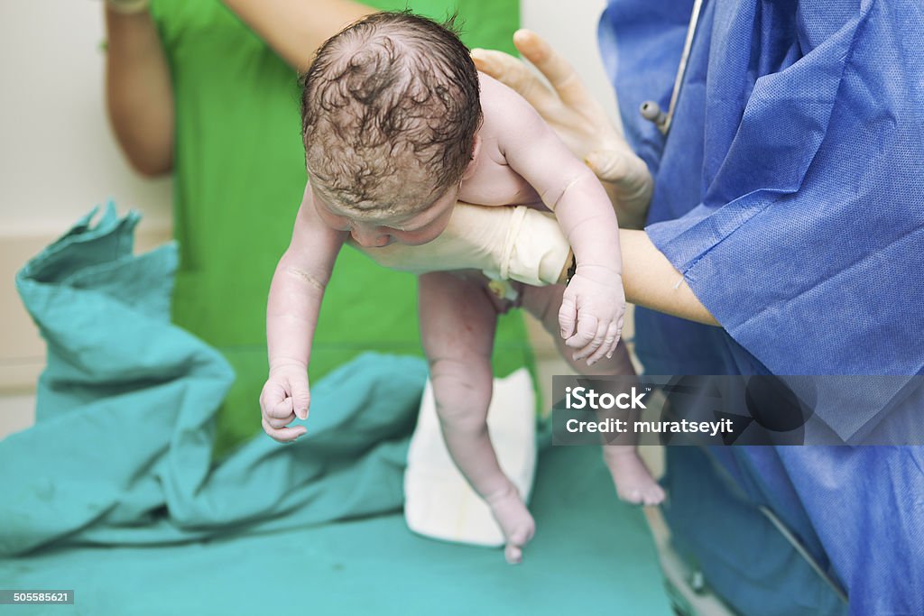 doctor holding a beautiful baby girl minutes after the birth Newborn Stock Photo