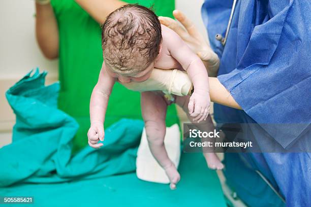 Doctor Holding A Beautiful Baby Girl Minutes After The Birth Stock Photo - Download Image Now