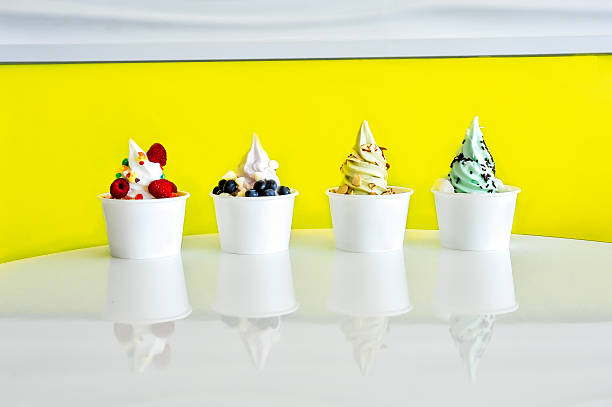 Frozen Yogurt Variety Line up Frozen yogurt flavors with various fruit toppings and candy toppings in a row. dessert topping stock pictures, royalty-free photos & images