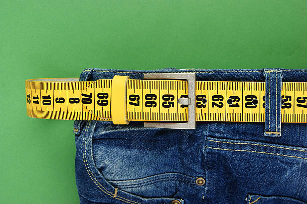 istock jeans with meter belt slimming on the green background 505587987