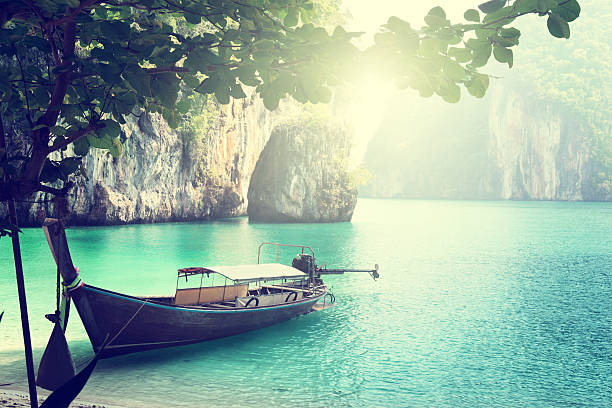 istock long boat on island in Thailand 505588139