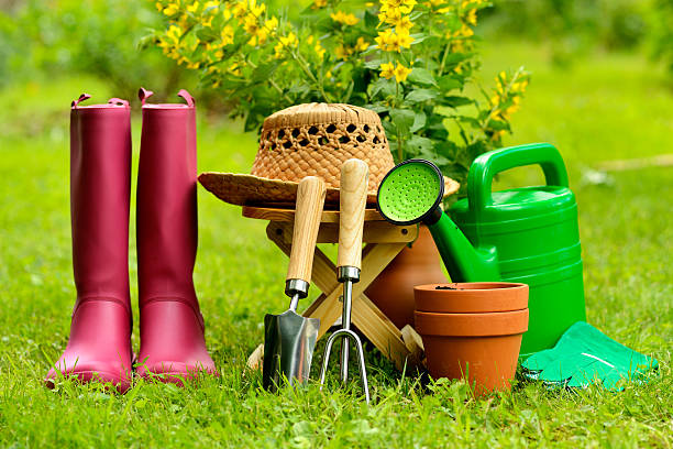 istock Gardening tools on green background and grass 505588953