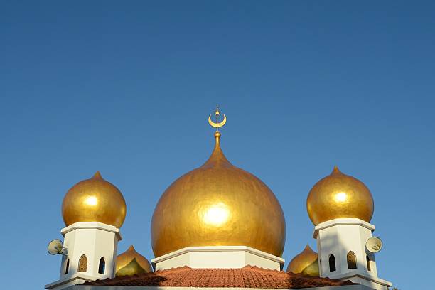 istock Gold dome of mosque in blue sky 505592816