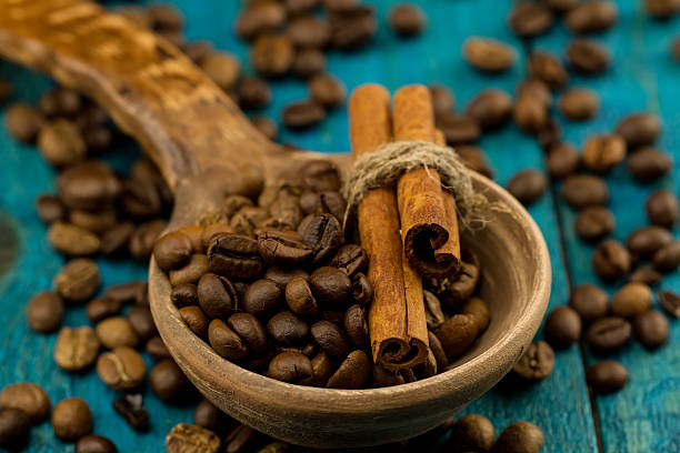 istock coffee beans in a spoon on blue wooden background 505595084
