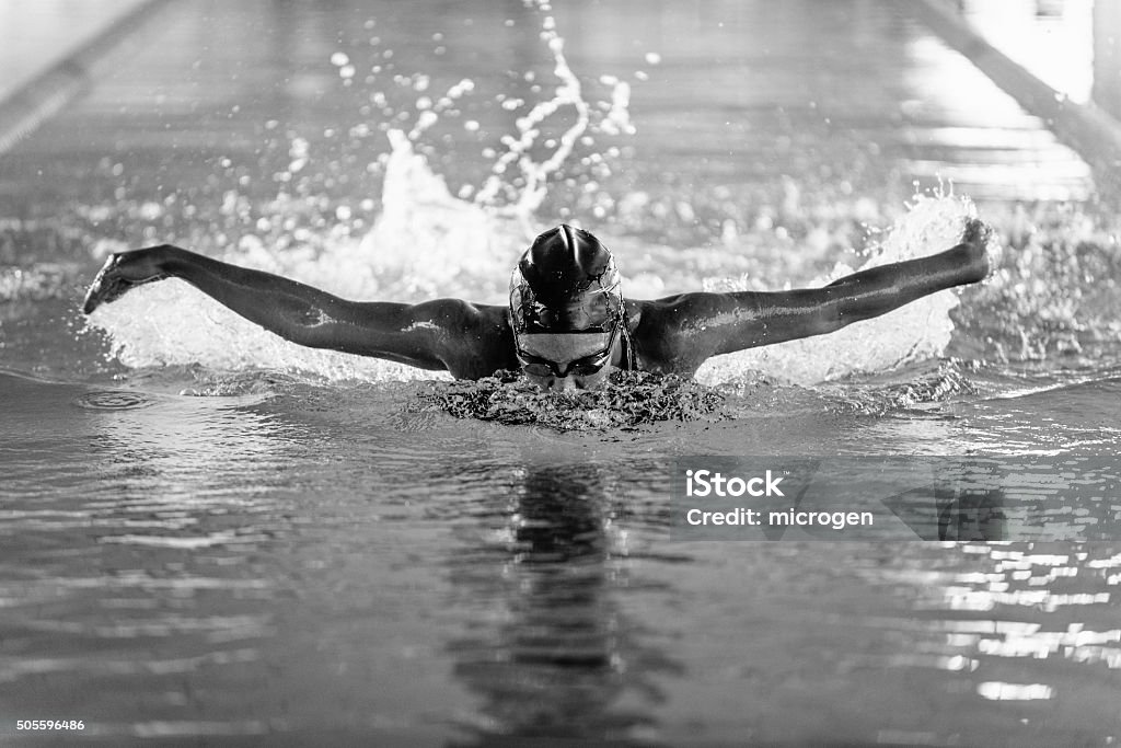 Butterfly style swimmer in action Butterfly style swimmer in action, black and white Black And White Stock Photo