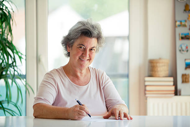 istock senior woman writing letter 505599118