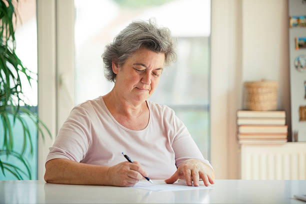 istock senior woman writing letter 505599404