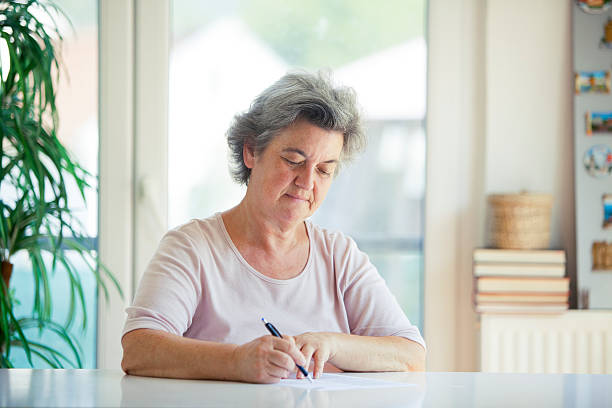 istock senior woman writing letter 505600214