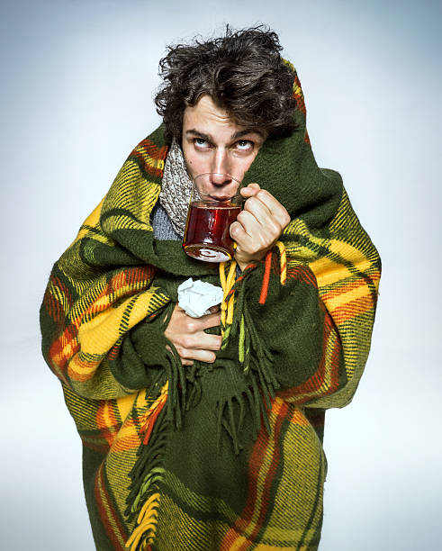 istock Ill Man covered with plaid blanket with hot tea 505600224