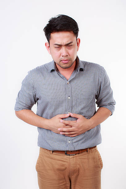 istock man with strong stomach pain 505600527
