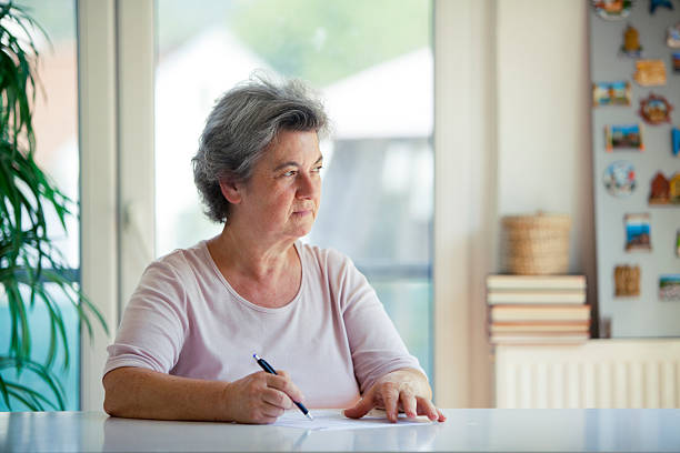 istock senior woman writing letter 505600540