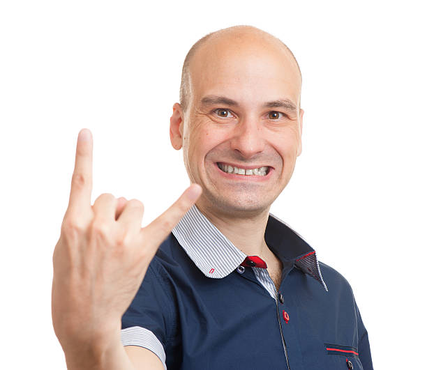 Happy Bald Man Doing A Rock Gesture Stock Photo - Download Image