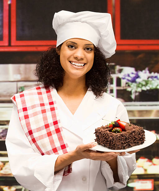 istock Cheerful female baker holding cake in bakery 505601668