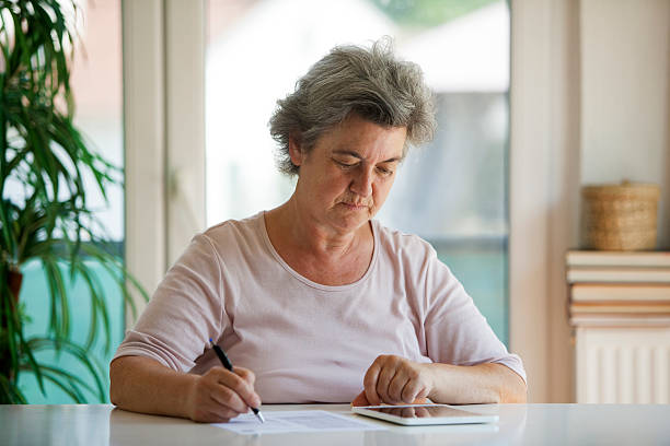 istock senior woman writing letter 505602080