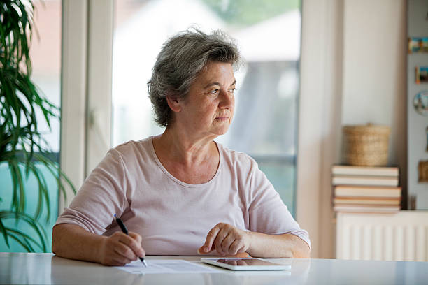 istock senior woman writing letter 505602450
