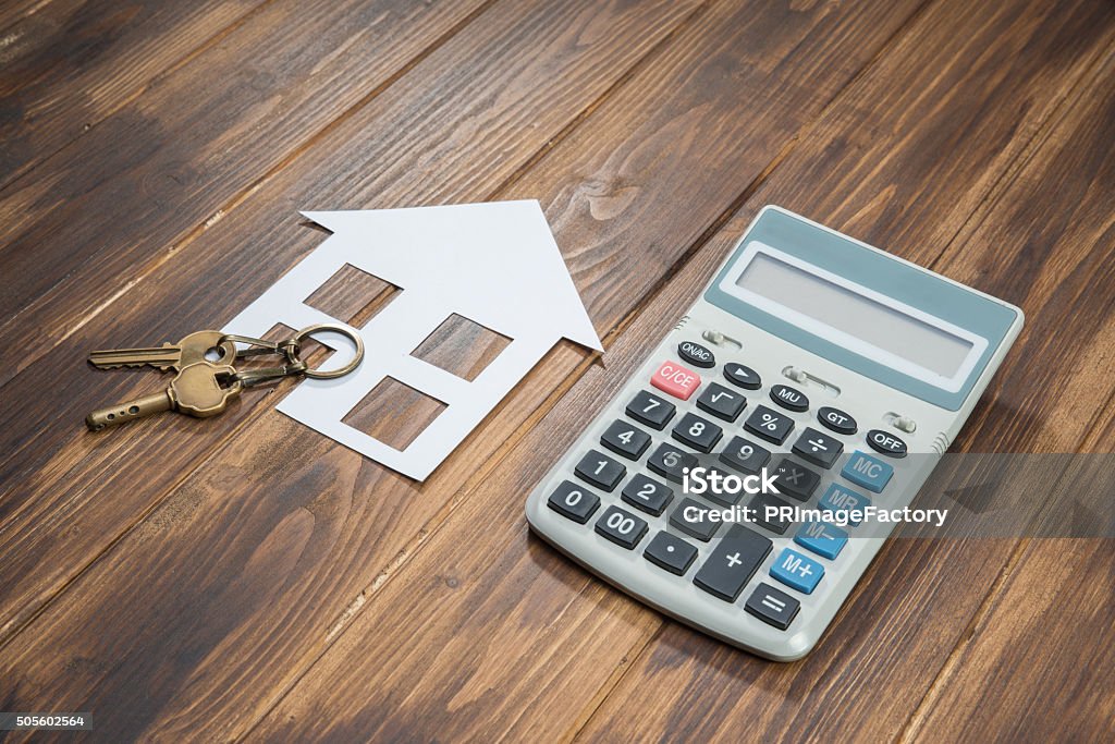 Mortgage Calculator, house and key with Calculator house and key with Calculator on wooden background Apartment Stock Photo