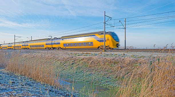 istock Electric train in a sunny frozen landscape 505602618
