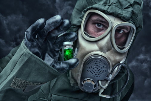 Man in a hazmat Suit holding vial