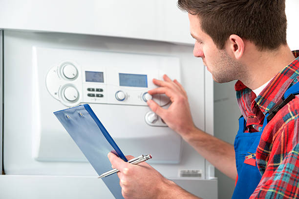 Technician servicing heating boiler Technician servicing the gas boiler for hot water and heating temperature control stock pictures, royalty-free photos & images