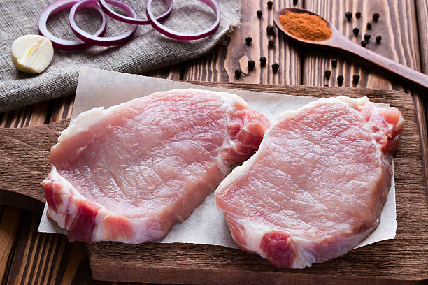 istock Fresh raw meat with onion and garlic on a wooden 505603890