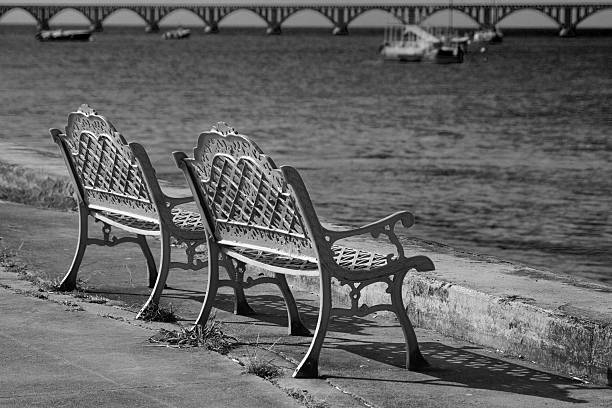 istock Metal bench, Malecon boardwalk, Samana, Dominican republic, black & white 505605349