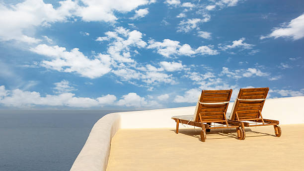 istock Two sunbathing on a roof terrace in Santorini 505606130